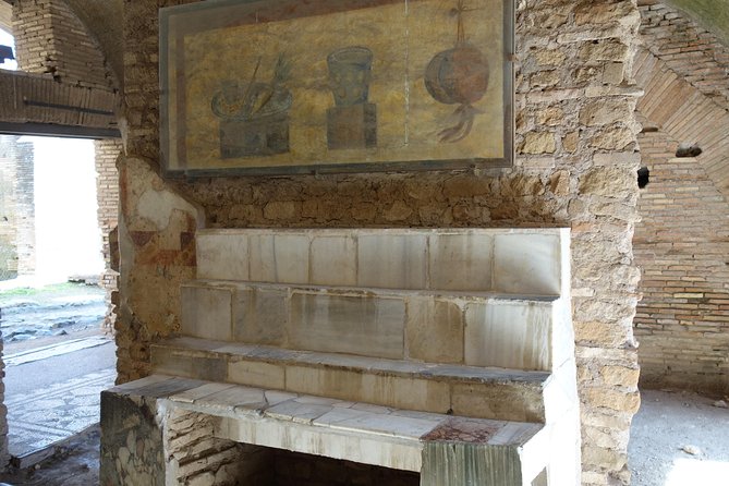 Ancient Ostia Antica Semi-Private Day Trip from Rome by Train with Guide - The Baths of Neptune and the city’s public spaces