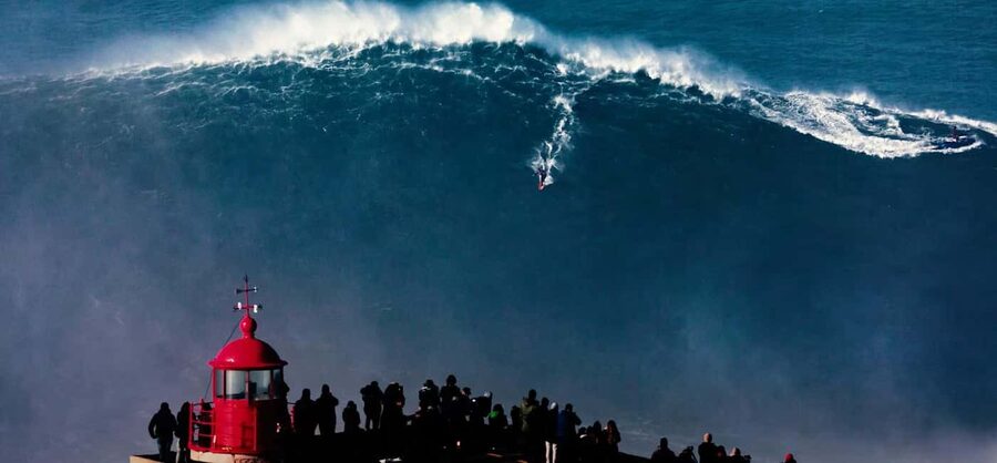 From Lisbon: Nazare Big Waves and Óbidos Guide Day Trip - Nazaré: cliffs, fishing boats, and powerful surf