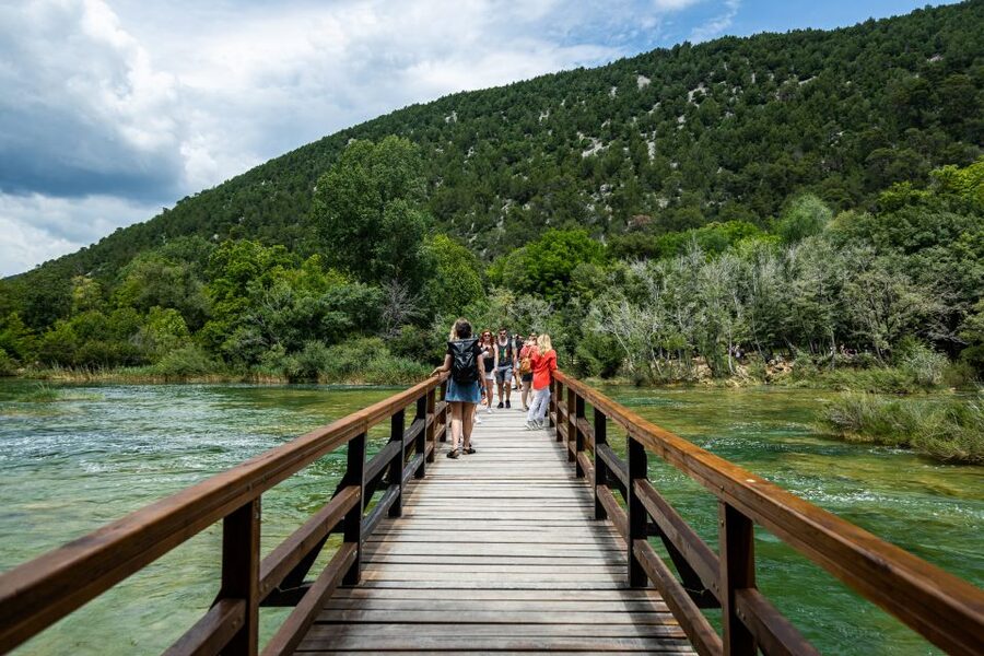 Split: Krka National Park Day Trip with Boat Ride & Swimming - Walking Krka’s waterfalls and wooden paths